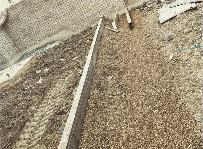 Edging boards set and sub-base laid for a new path