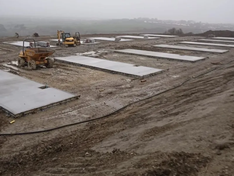 Concrete pads poured in rows across a new site